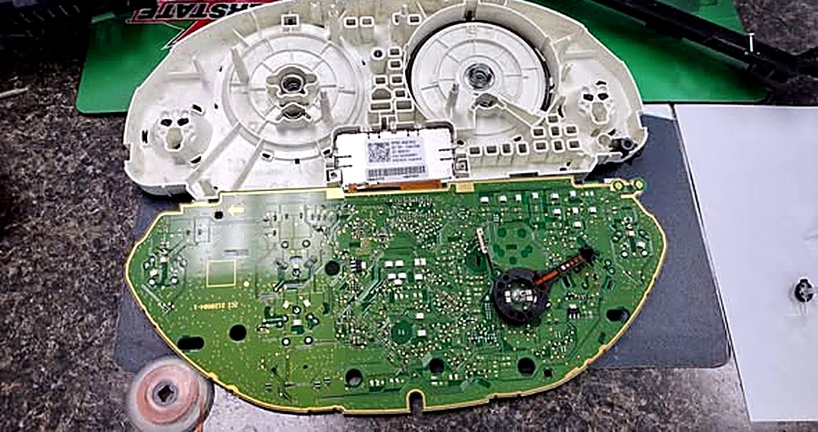 The instrument cluster taken apart, with its circuit board separated from the housing