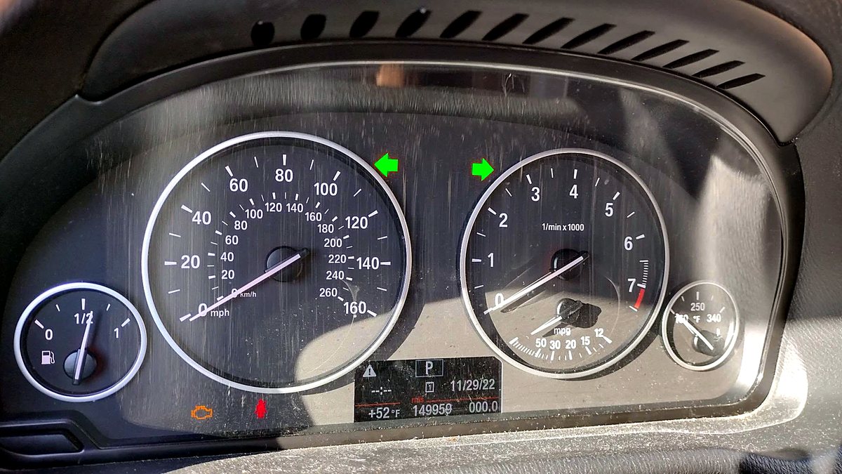 The repaired instrument cluster back in the vehicle with both turn signal indicators lit