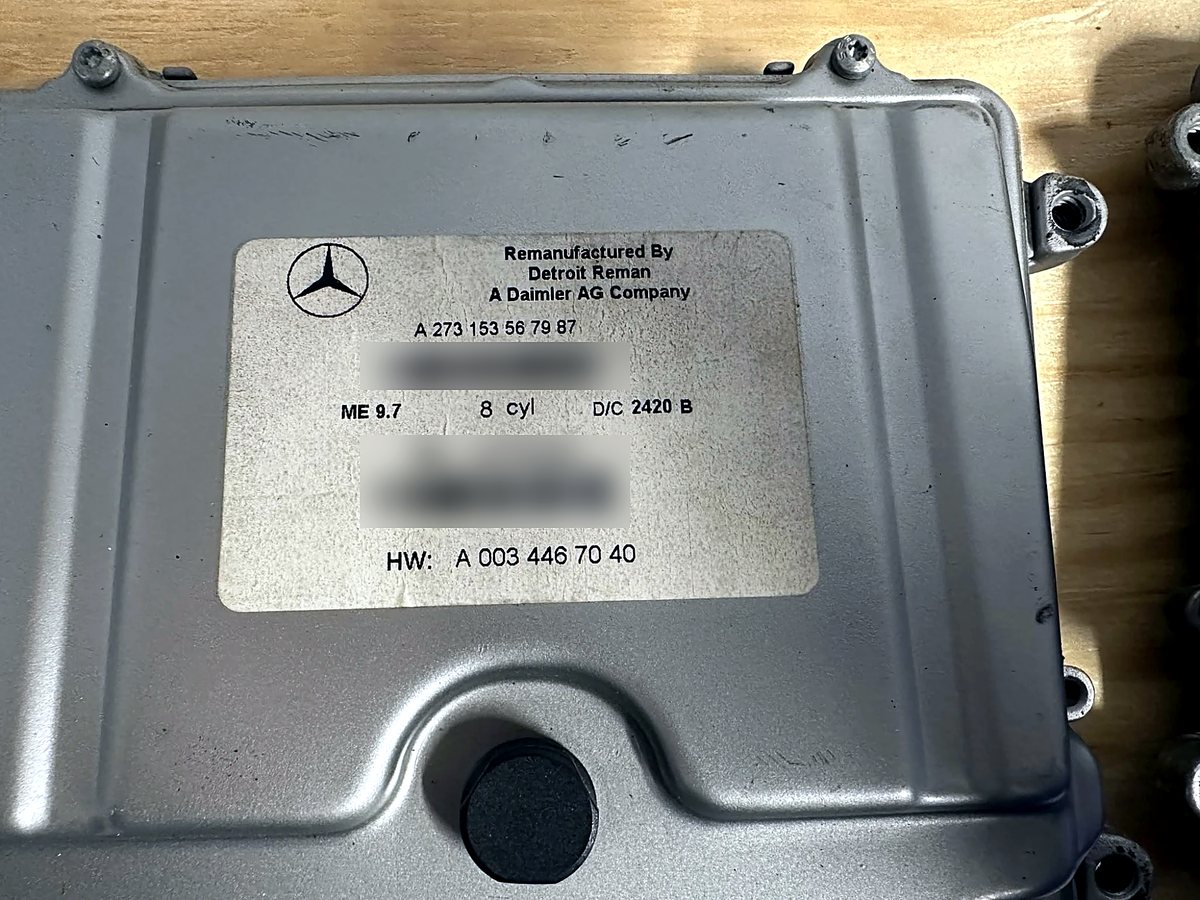 The label side of a Mercedes ME 9.7 engine control module on the bench